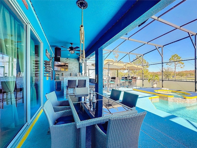 view of patio / terrace with glass enclosure and a swimming pool with hot tub