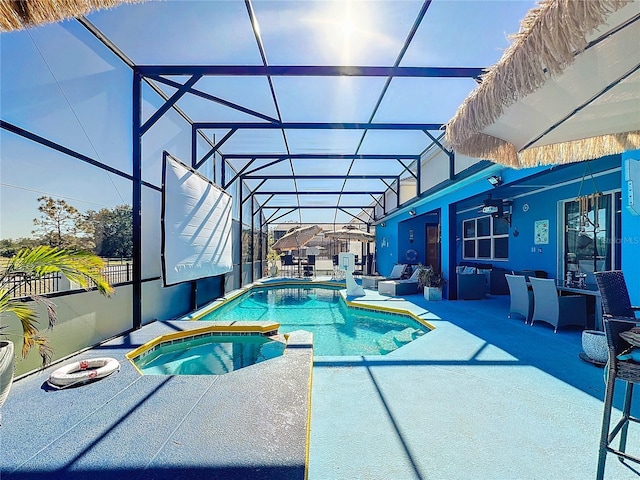 view of swimming pool with a patio area, an in ground hot tub, ceiling fan, and glass enclosure