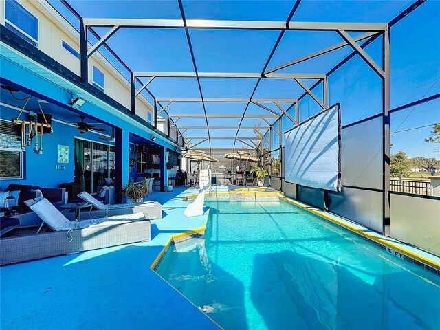 view of pool with a patio area and a lanai