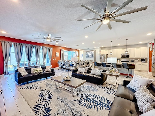 tiled living room with a healthy amount of sunlight and a textured ceiling