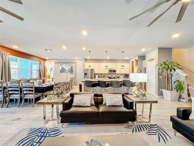 tiled living room featuring a textured ceiling