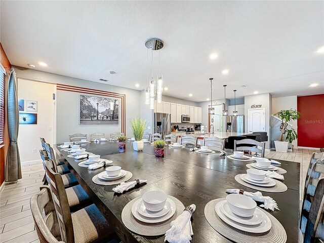 dining room featuring sink and light wood-type flooring