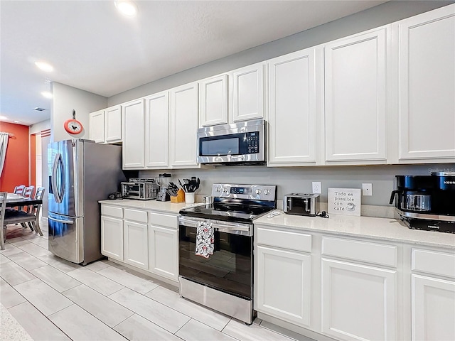 kitchen featuring white cabinetry and stainless steel appliances