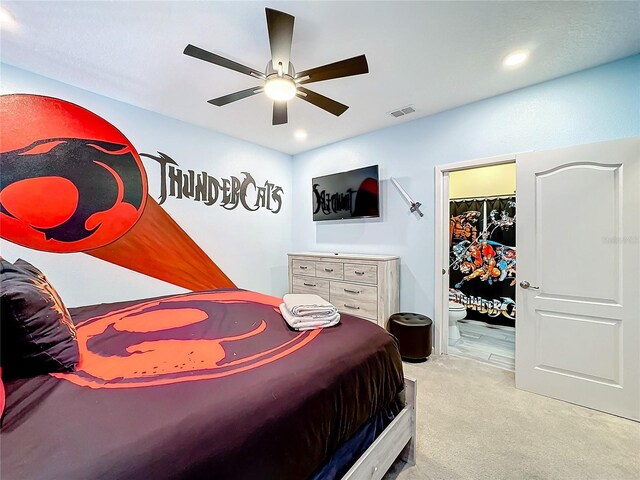 bedroom with a closet, light colored carpet, a spacious closet, and ceiling fan