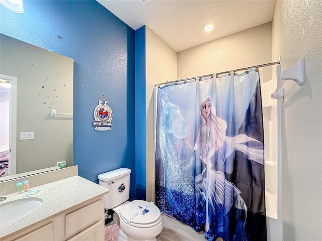 bathroom featuring a shower with curtain, vanity, and toilet