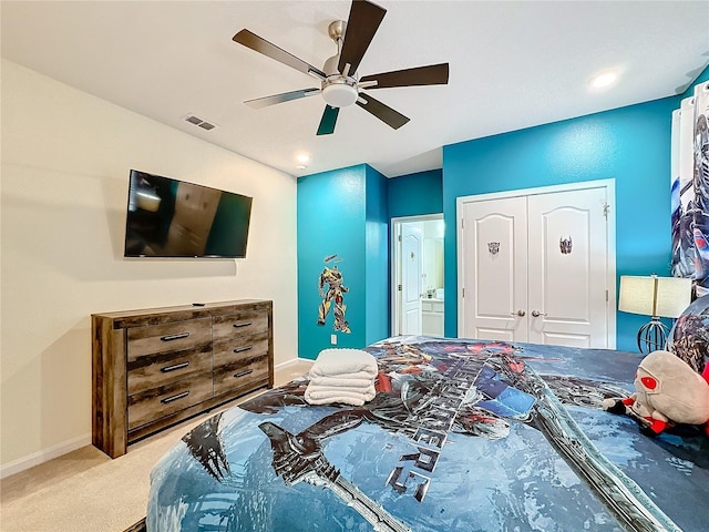 carpeted bedroom featuring ceiling fan and a closet