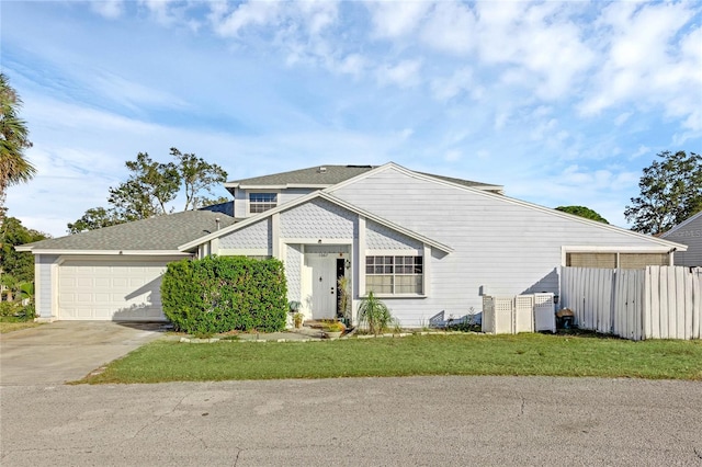 view of front of home with a garage and a front lawn