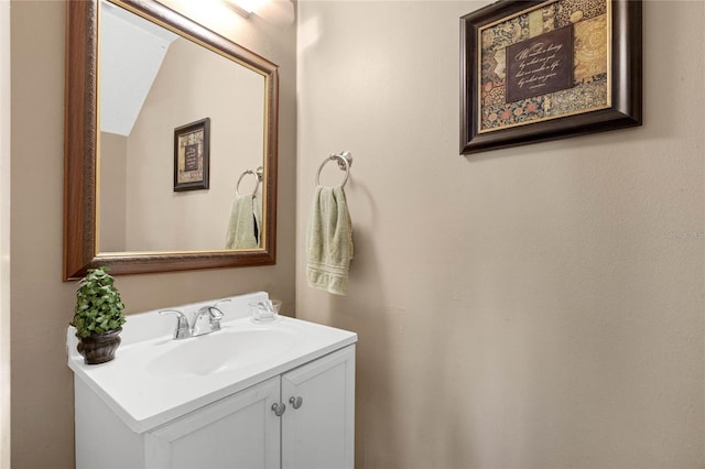 bathroom with vanity and vaulted ceiling