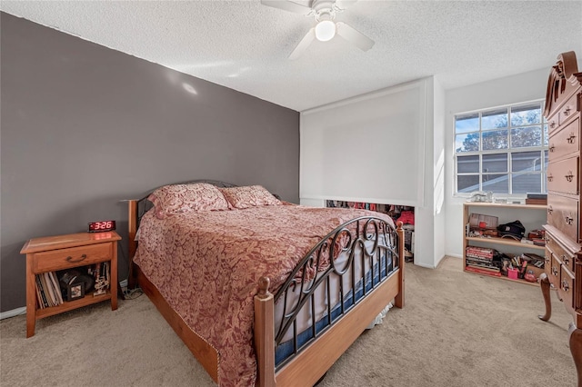 carpeted bedroom featuring a textured ceiling and ceiling fan