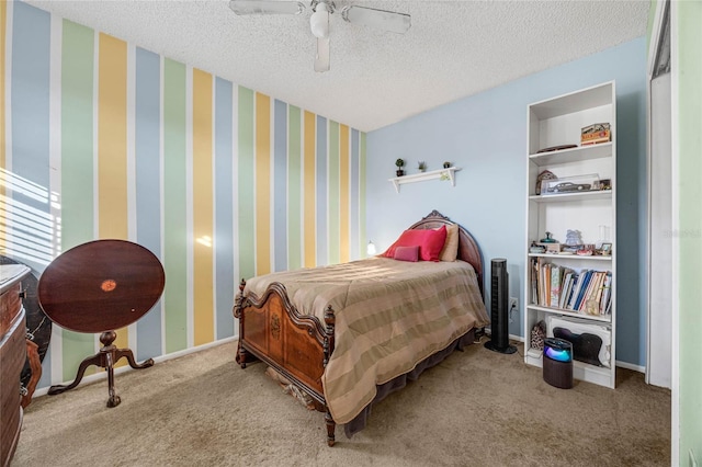 bedroom featuring ceiling fan, light carpet, and a textured ceiling