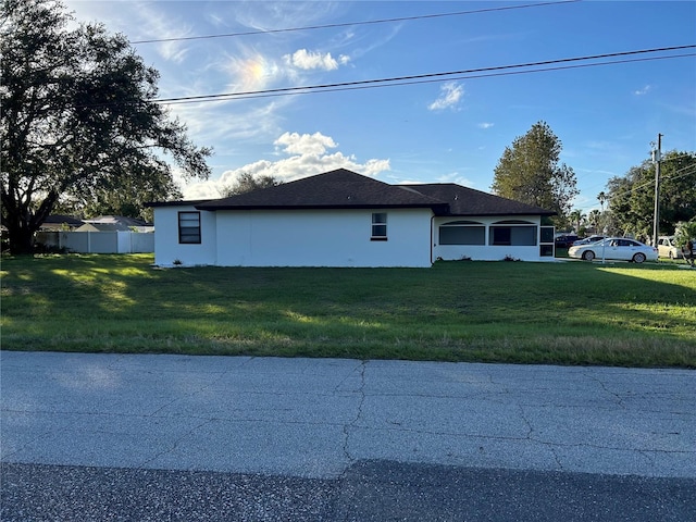 view of property exterior with a lawn