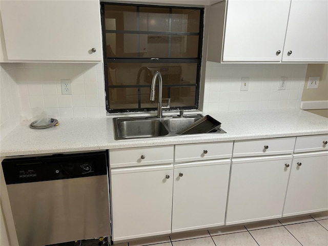 kitchen with white cabinetry, stainless steel dishwasher, tasteful backsplash, and sink