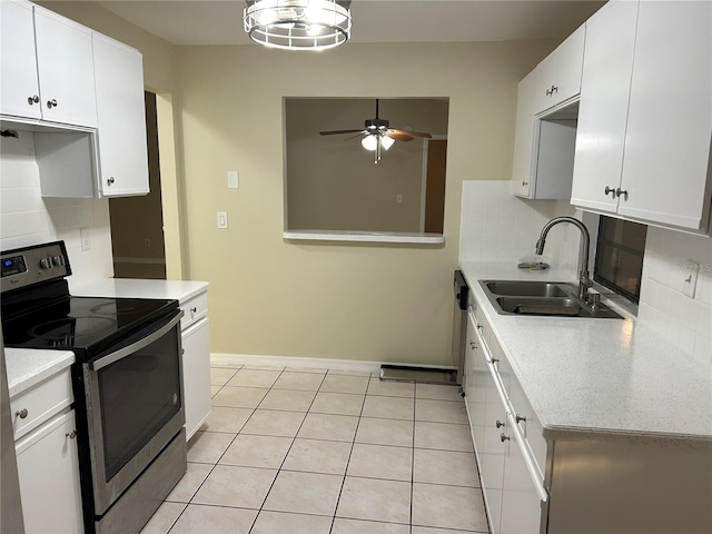 kitchen featuring backsplash, stainless steel range with electric stovetop, ceiling fan, sink, and white cabinetry