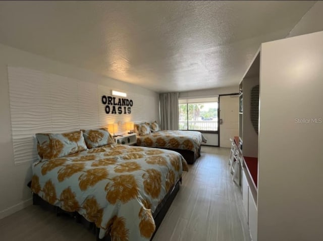 bedroom featuring hardwood / wood-style floors and a textured ceiling