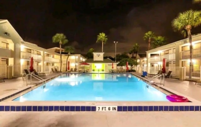 pool at night with a patio