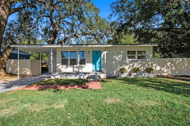 view of front facade with a front lawn and a carport