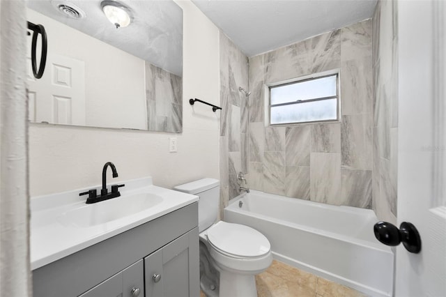 full bathroom with tiled shower / bath combo, tile patterned flooring, a textured ceiling, toilet, and vanity