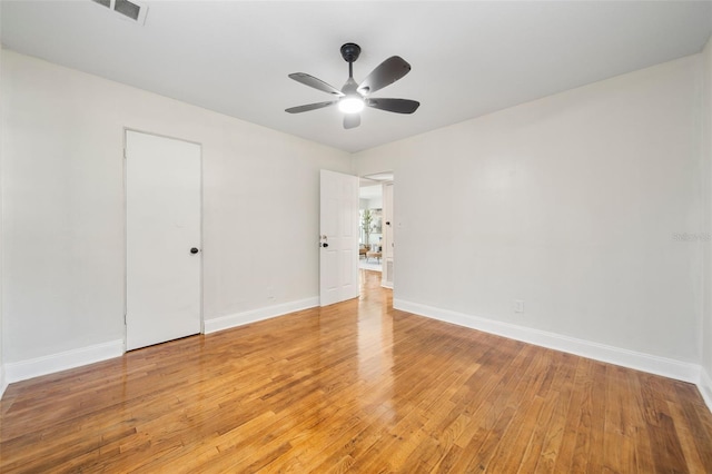 empty room with light hardwood / wood-style floors and ceiling fan