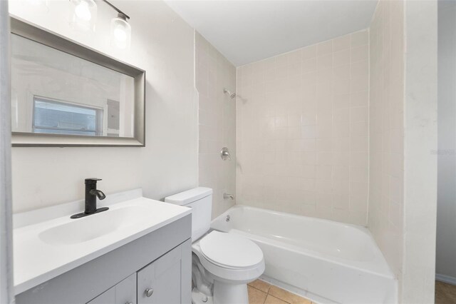 full bathroom featuring tile patterned floors, vanity, toilet, and tiled shower / bath