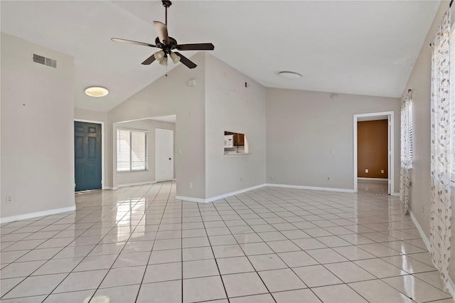 spare room featuring ceiling fan, light tile patterned flooring, and high vaulted ceiling