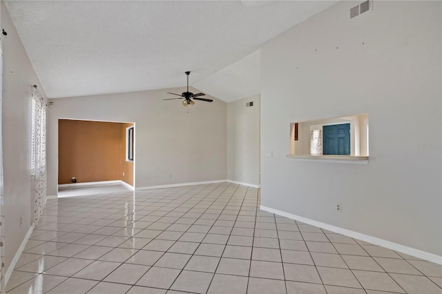 spare room featuring ceiling fan, light tile patterned flooring, and high vaulted ceiling