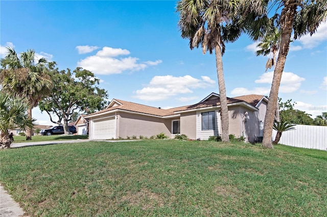 ranch-style home with a front yard and a garage