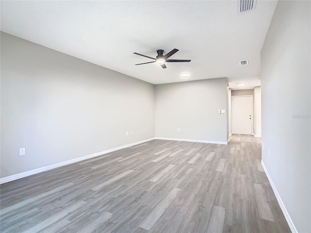 spare room with ceiling fan and light wood-type flooring