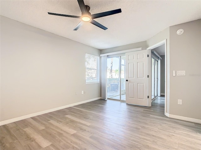 empty room with light wood-type flooring and ceiling fan