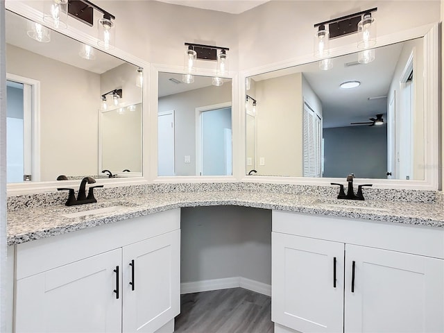 bathroom with hardwood / wood-style floors, vanity, and ceiling fan