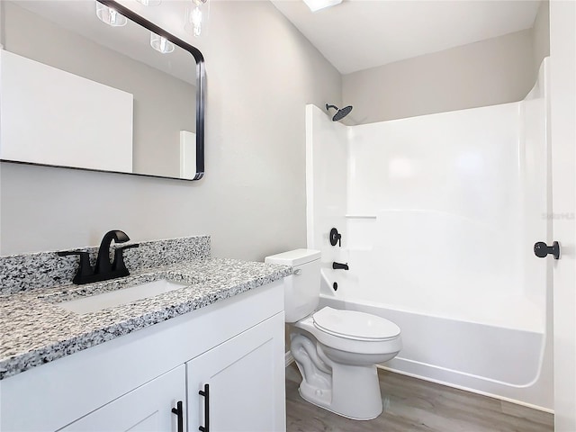 full bathroom with vanity, hardwood / wood-style flooring, toilet, and shower / bathtub combination