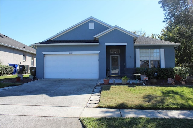 view of front of house with a front yard and a garage