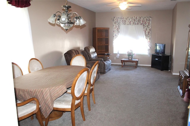 dining room with carpet floors and ceiling fan with notable chandelier