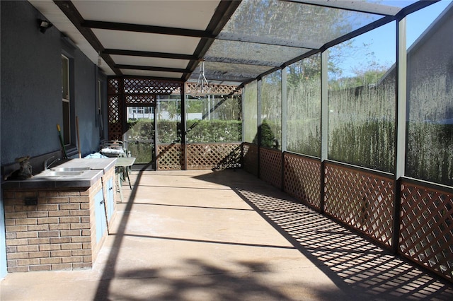 view of patio featuring a lanai and sink