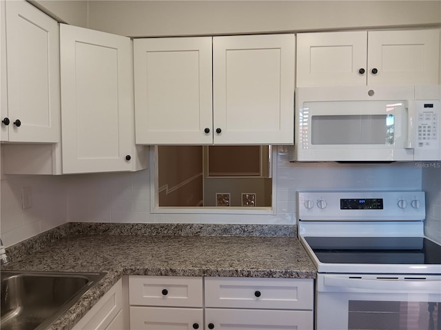 kitchen featuring a sink, white appliances, backsplash, and white cabinets