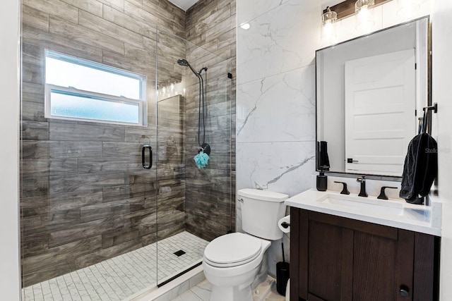 bathroom featuring vanity, a shower with shower door, tile walls, and toilet