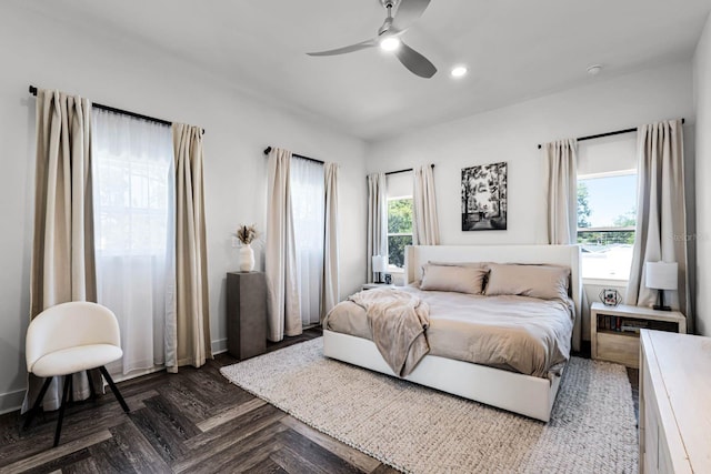 bedroom with ceiling fan and dark parquet floors