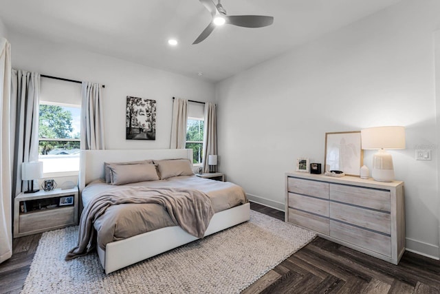 bedroom with ceiling fan and dark parquet flooring