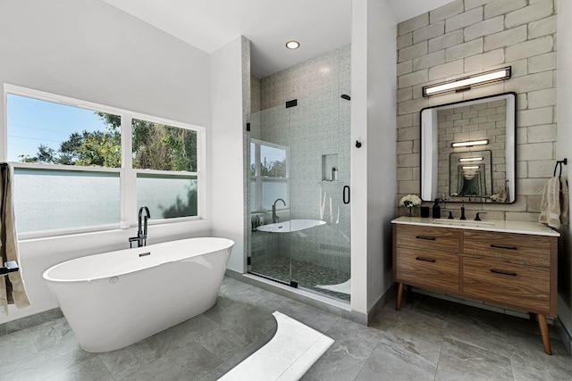 bathroom featuring vanity and independent shower and bath