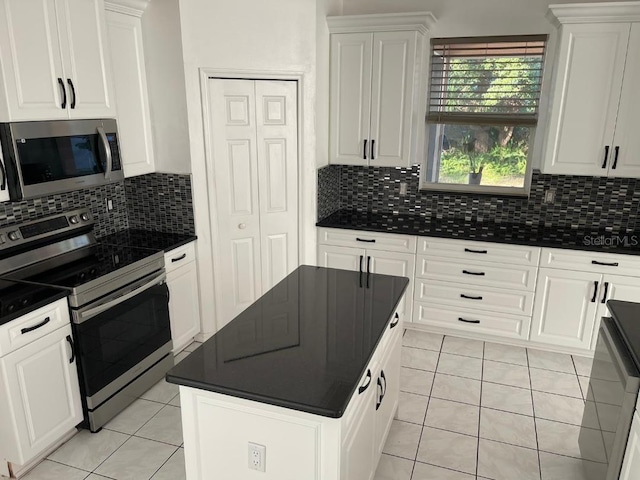 kitchen featuring decorative backsplash, white cabinetry, and appliances with stainless steel finishes