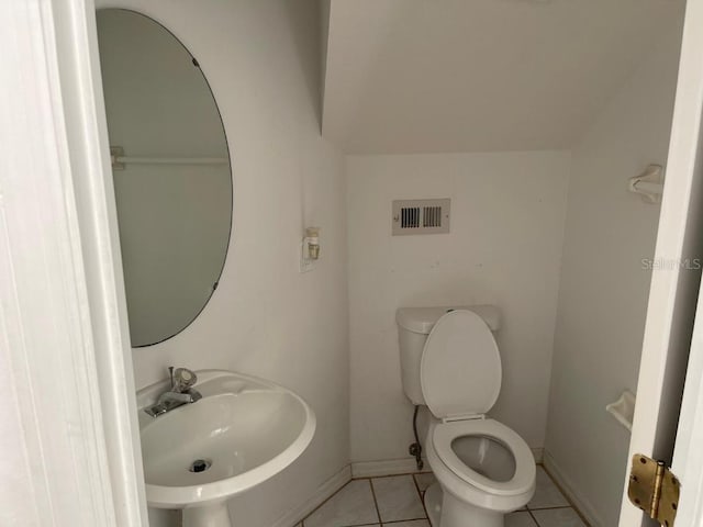 bathroom featuring tile patterned flooring, toilet, and sink