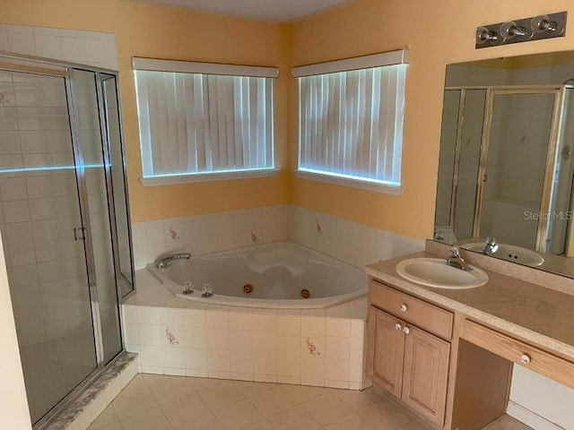 bathroom featuring tile patterned flooring, shower with separate bathtub, and vanity