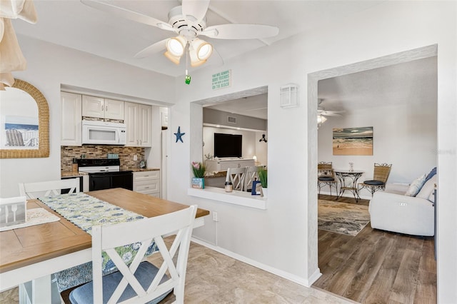 dining room featuring light hardwood / wood-style flooring and ceiling fan