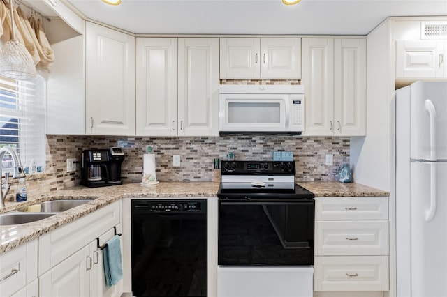 kitchen with decorative backsplash, white appliances, white cabinetry, and sink