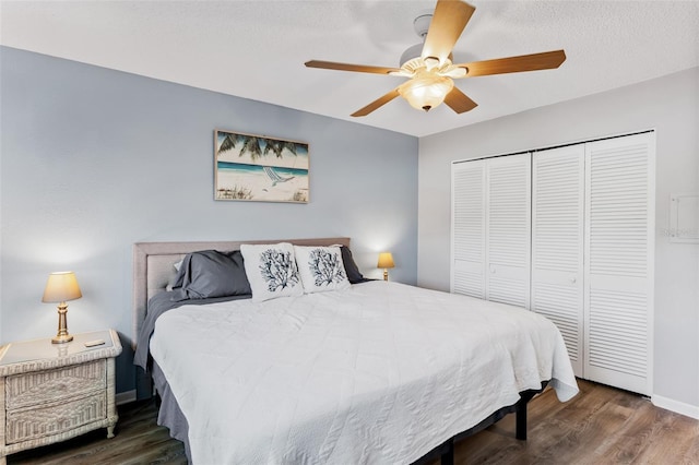 bedroom featuring ceiling fan, a closet, and dark hardwood / wood-style floors