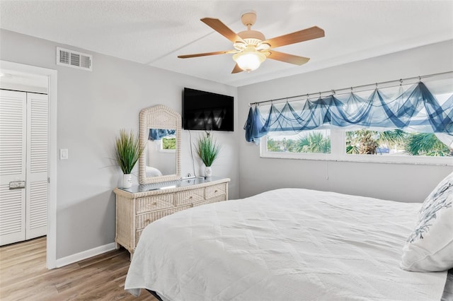 bedroom with a closet, ceiling fan, and hardwood / wood-style floors