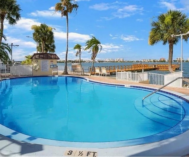 view of pool featuring a water view