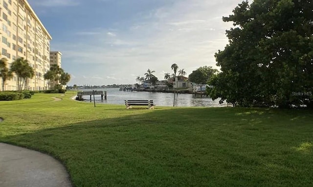 view of home's community with a yard and a water view