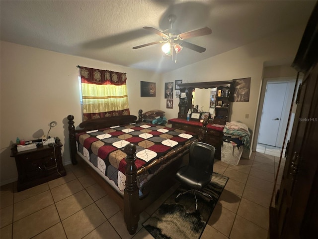 bedroom featuring a textured ceiling, vaulted ceiling, tile patterned floors, and ceiling fan