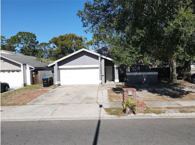 single story home featuring an attached garage and driveway