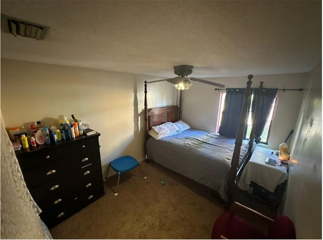bedroom with visible vents, a textured ceiling, carpet, and ceiling fan